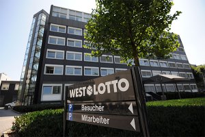 Westlotto Headquarter with a sign and a tree